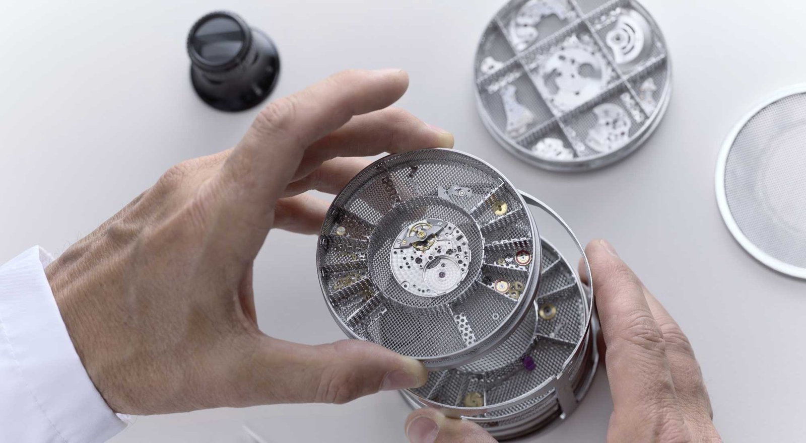 Rolex watch components being cleaned in ultrasonic bath