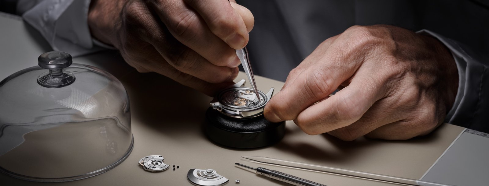 Watchmaker dismantling a Rolex movement